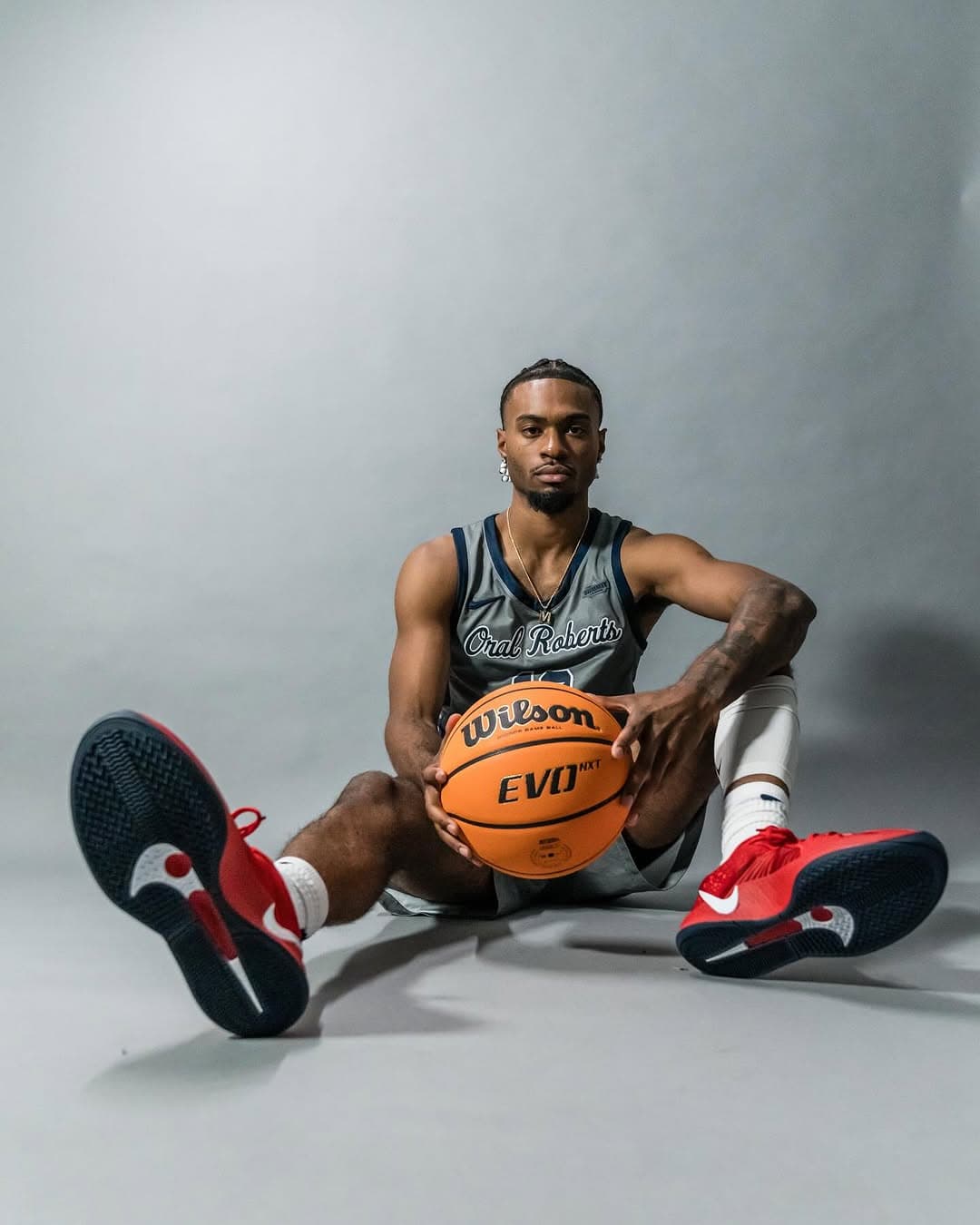 Issac McBride - Oral Roberts seated with basketball